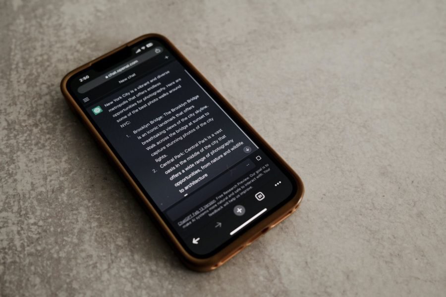 ChatGPT: a cell phone with a text generating conversation on ChatGPT