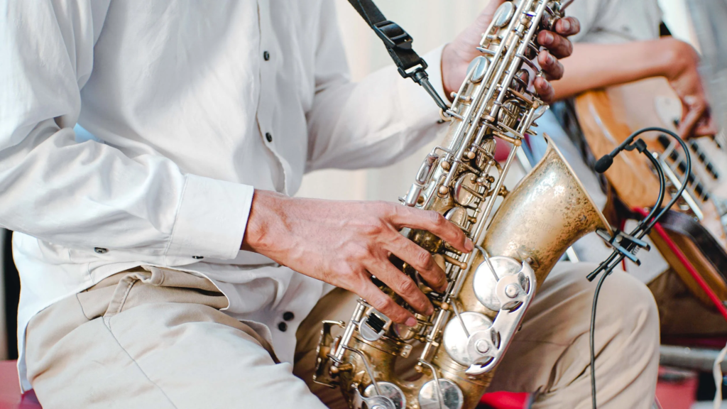 Playing An Instrument. pic of a man playing saxophone