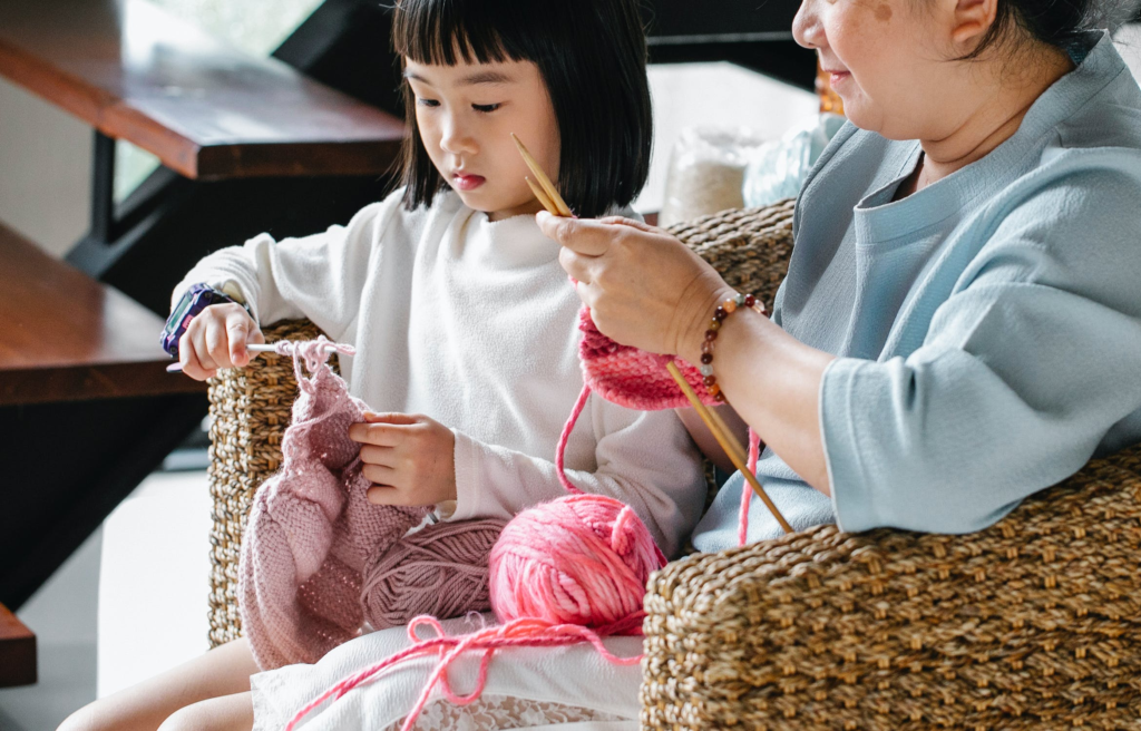 Crafting For Various Projects. pic of a mom crafting next to her child.