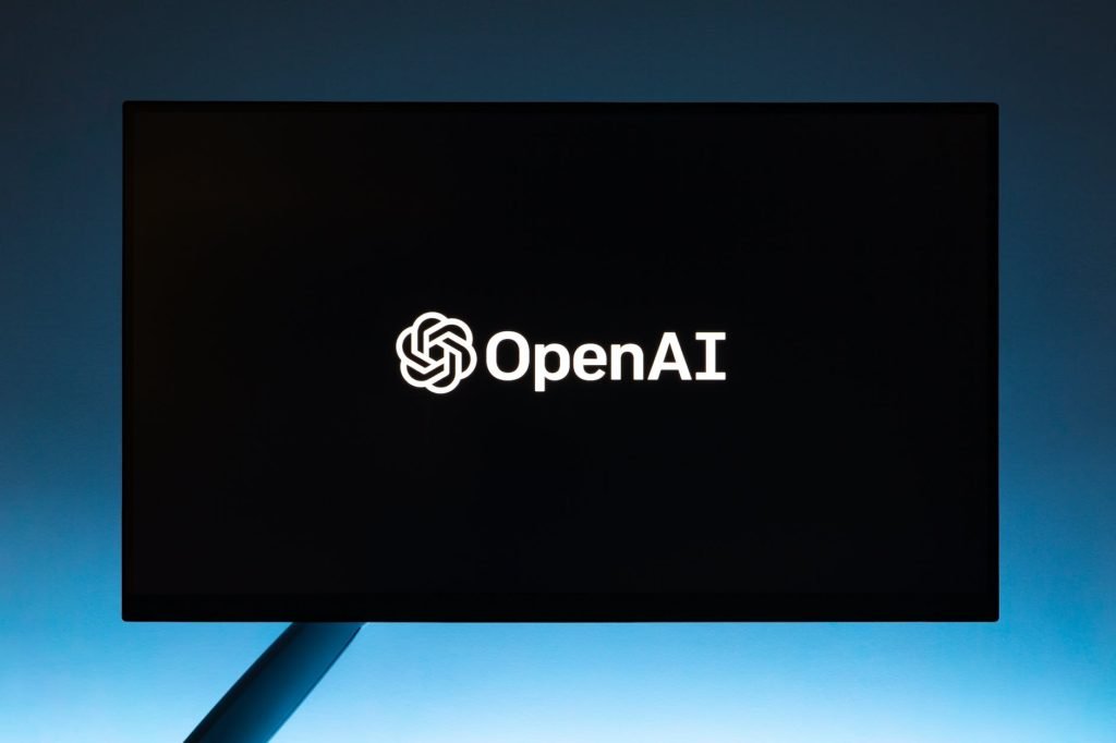 monitor screen with openai logo on black background: Does ChatGPT API Cost Money & How Much?