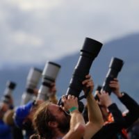 people holding dslr cameras: highest paying photography niche