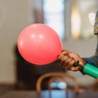 black man inflating balloon with pump: Free Text Inflator - Best Online Tool