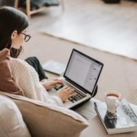 List of 10 Paraphrasing Sentences Examples: young woman typing on laptop on sofa