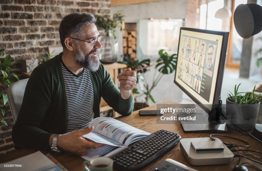 teacher with his students eaching them online on zoom/google meet
